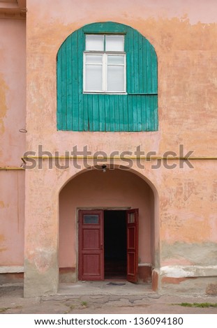 Building Facade: windows and old wall with arch door