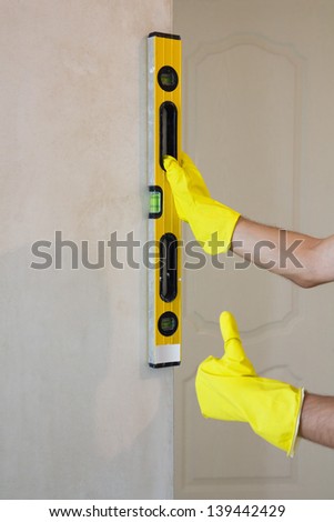 Hands with spirit level working on home renovations