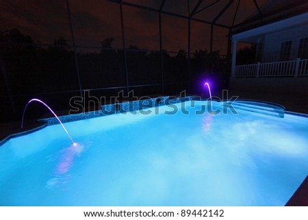 A Swimming Pool lit up at Night