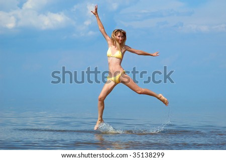 The woman in a bathing suit jumps on water