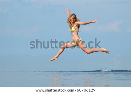 The woman in a bathing suit jumps on water