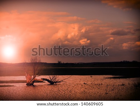 Rural scenery and inside water in sunset with ray of sunshine