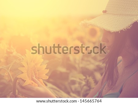 stock-photo-vintage-photo-of-young-woman-and-sunflowers-145665764.jpg