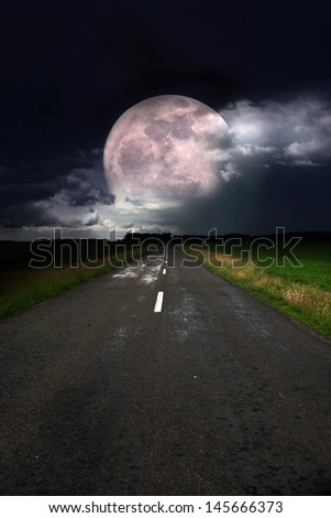 Asphalt road and moon