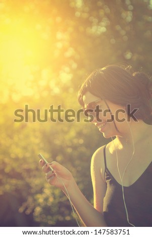 Girl listening to music through headphones