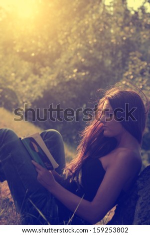 Vintage Photo Of Young Woman Reading A Book In Park