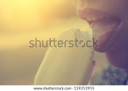 Vintage photo of closeup woman lips eating ice cream