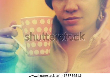 Woman holding retro coffee mug