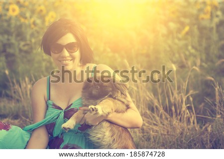 Vintage photo of young woman with pekingese dog