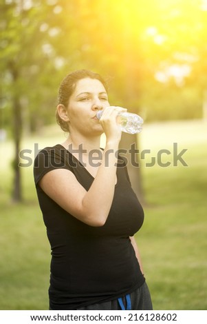 Woman drinking water after sport