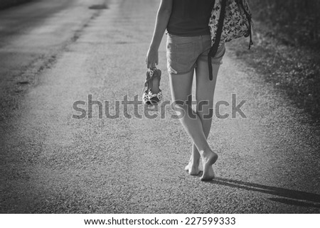 Woman walking away with a backpack