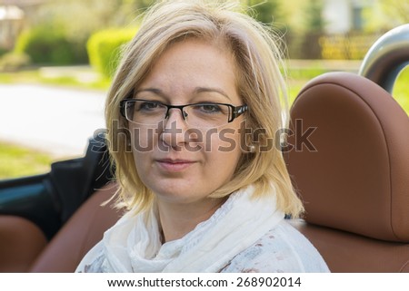 Natural blonde woman in cabrio sport car