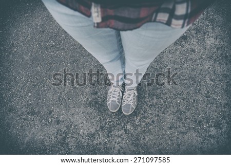 The girl\'s legs and retro shoes. Analog effected photo