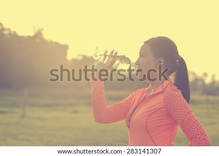 Tired runner woman drink water