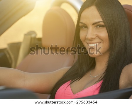 Sexy young woman in cabriolet car
