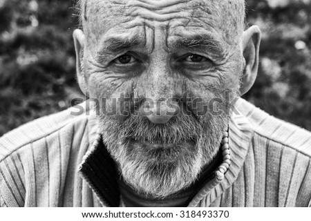 Sad homeless senior man
