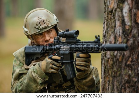 operator holding a gun aiming through the scope
