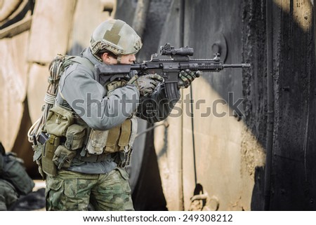 military soldier shooting an assault rifle