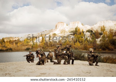 U.S. Soldiers takes a break on a berm during patrol the area
