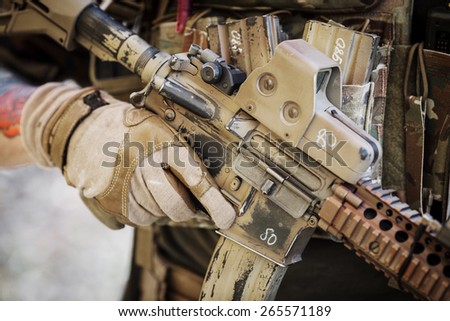 ranger in gloves holding assault automatic rifle
