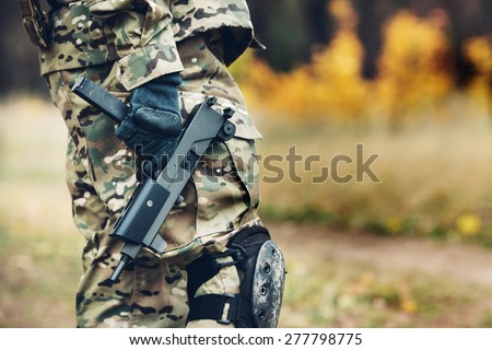 Special forces soldier with rifle in the forest