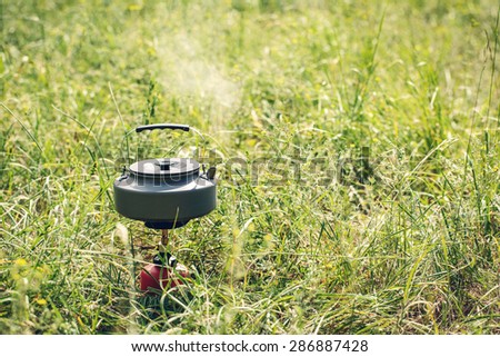 boiling water in titanium kettle on portable camping stove