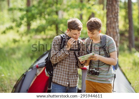 Young tourists talk on the radio, and specify your route