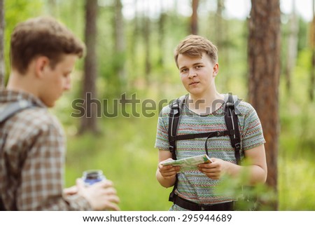 young tourist determine the route map and compass