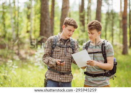 two young tourist determine the route map and navigator