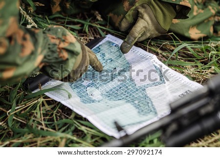 Ranger commander explains the combat mission and points to a paper map