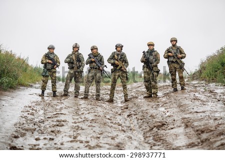 rangers special team standing with rifle and looking at camera