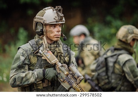 Portrait of a ranger in the battlefield with a rifle