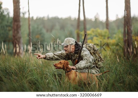 Hunter with Rifle and Dog in forest