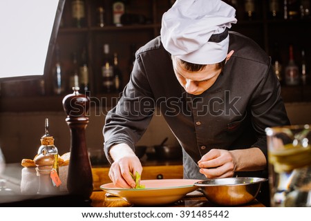 chef prepares broccoli green soup puree with celery on the wooden background. vegetarian diet, cooking,