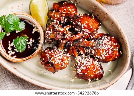 chicken wings in sauce teriyaki grilled on plate. restaurant menus, healthy eating, homemade, gourmands, gluttony.