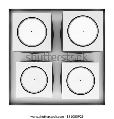 top view of four metallic candlesticks with candles isolated on white background
