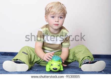 small boy play home smile blue carpet hedgehog toy hand