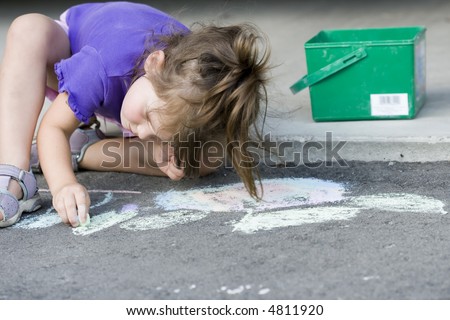 girl drawing on the asphalt