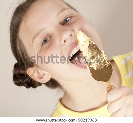 stock photo girl licking cake spatula