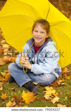 smiling girl under yellow umbrella