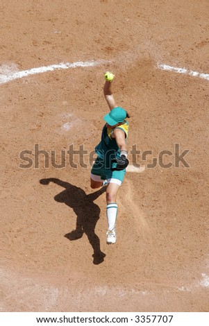 An aerial view of a female softball pitcher in action during a game.