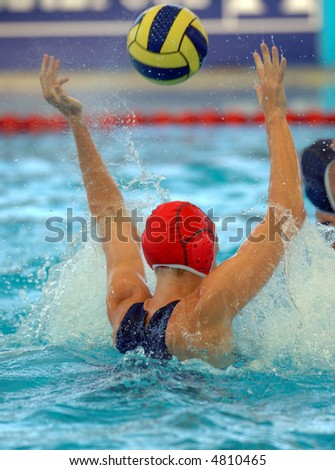 A female water polo goalie misses a shot
