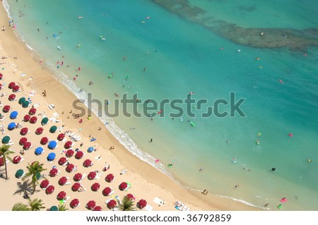 a birds eye view of holiday makers on a resort beach