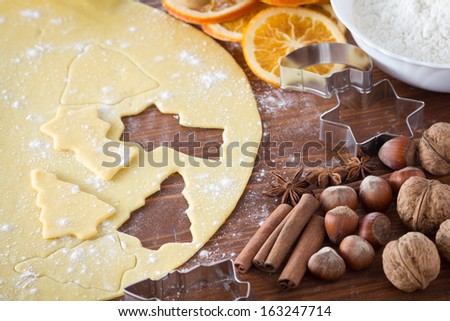Christmas cookie dough, cookie cutters, spices and nuts