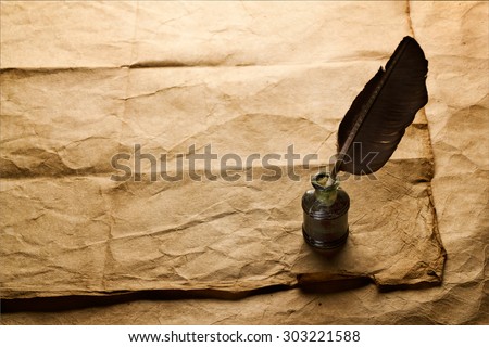 quill pen and inkwell on vintage paper background