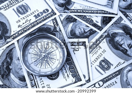Closeup of compass and money