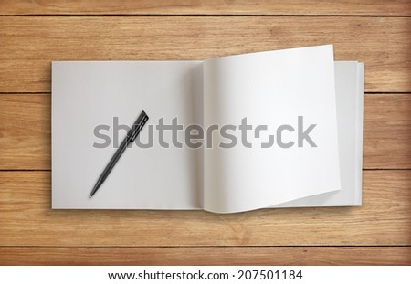 Notebook paper with pen on wooden floor