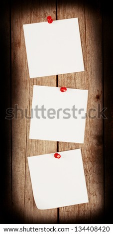 Three white sheet of paper on the background of the boards