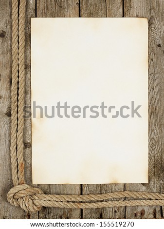 Piece of old faded paper on the wooden background