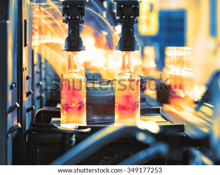 Moving assembly line for production of glass bottles shot in motion